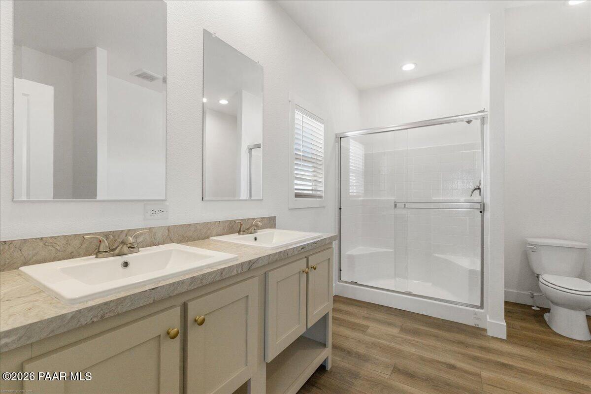65 Hawaii Road Paulden, AZ 86334 - Photo 17 of 29 a bathroom with a sink toilet a mirror and shower