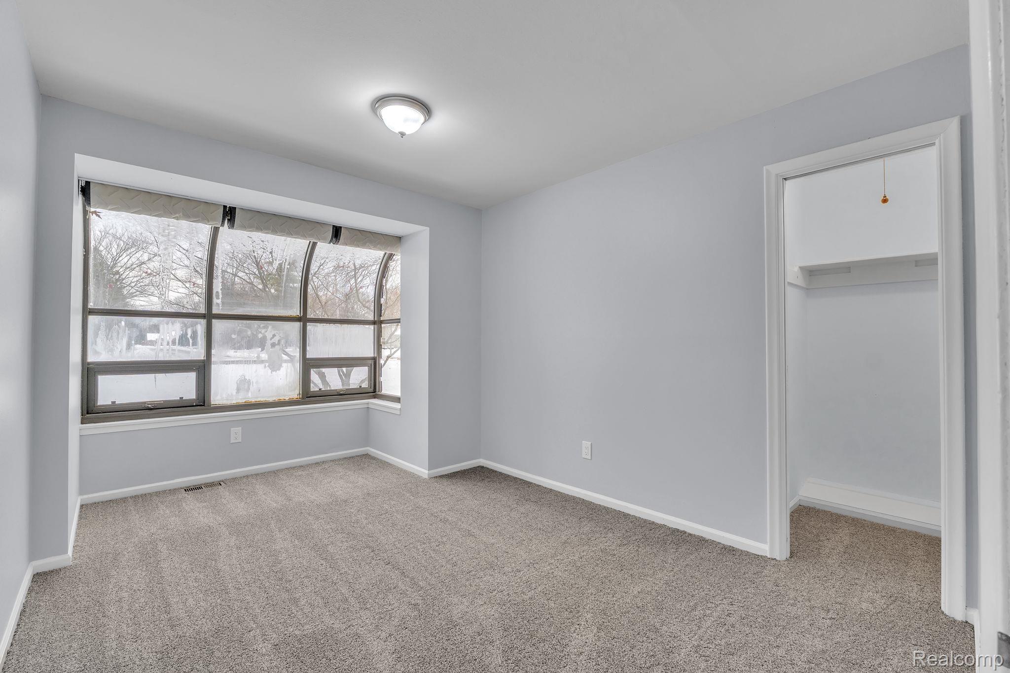 6576 Inkster Road West Bloomfield, MI 48322 - Photo 44 of 62 Unfurnished bedroom featuring a spacious closet and light carpet