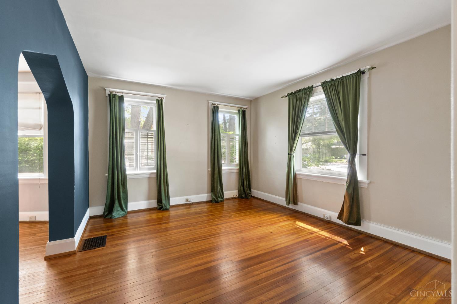 6606 Murray Road Cincinnati, OH 45227 - Photo 6 of 29 The living room has hardwood floors and plantation shutters/blinds.