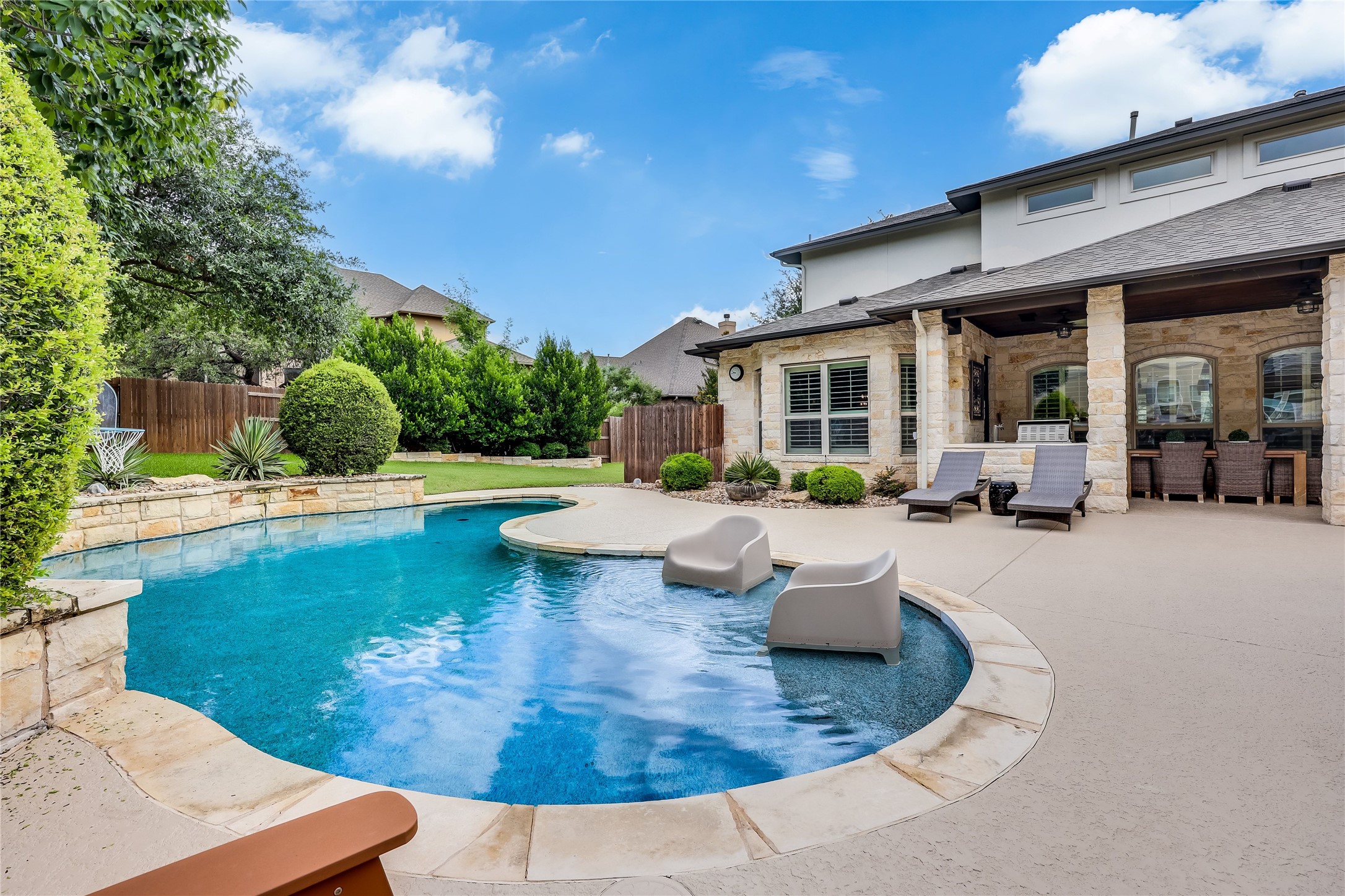 401 Bluff View Road Cedar Park, TX 78613 - Photo 12 of 40 An inviting backyard oasis awaits with a sparkling pool, generous patio, and lush landscaping.