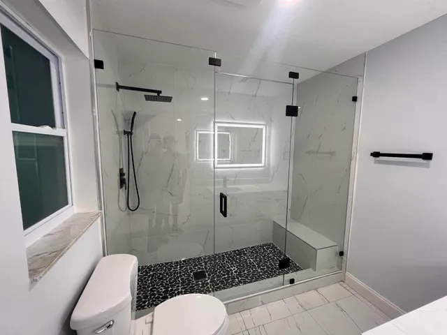 a bathroom with a sink toilet and shower