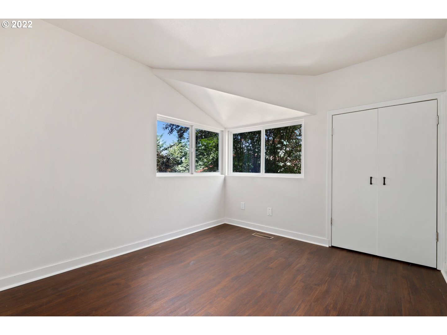 3143 Southwest Sherwood Place Portland, OR 97201 - Photo 17 of 32 an empty room with wooden floor and windows