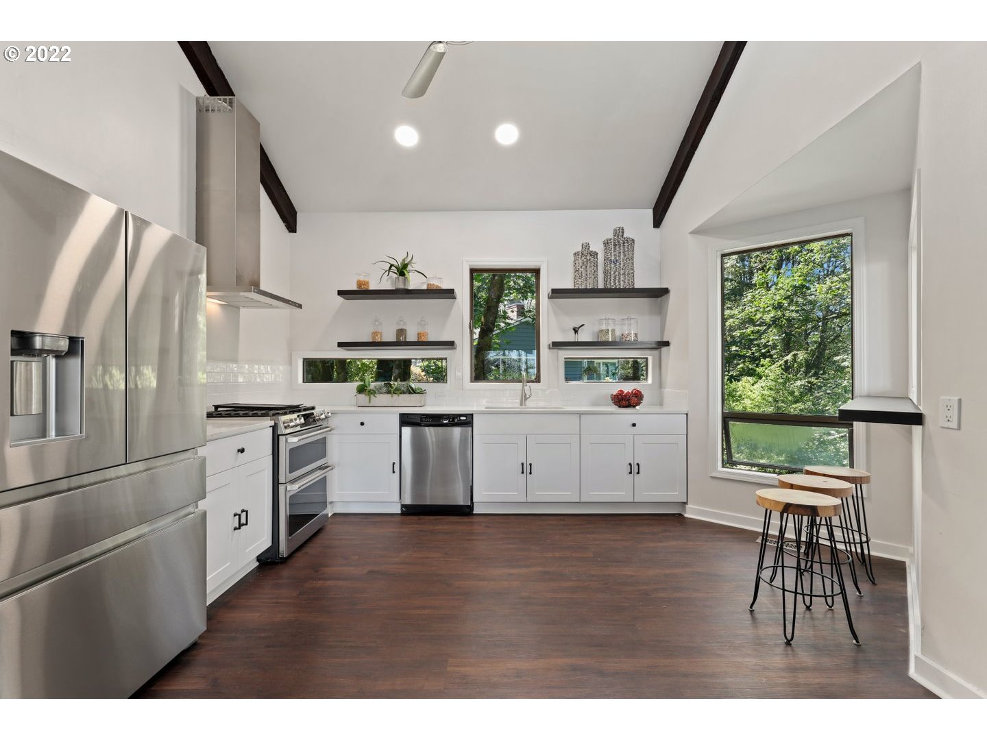 3143 Southwest Sherwood Place Portland, OR 97201 - Photo 6 of 32 a kitchen with white cabinets and white appliances