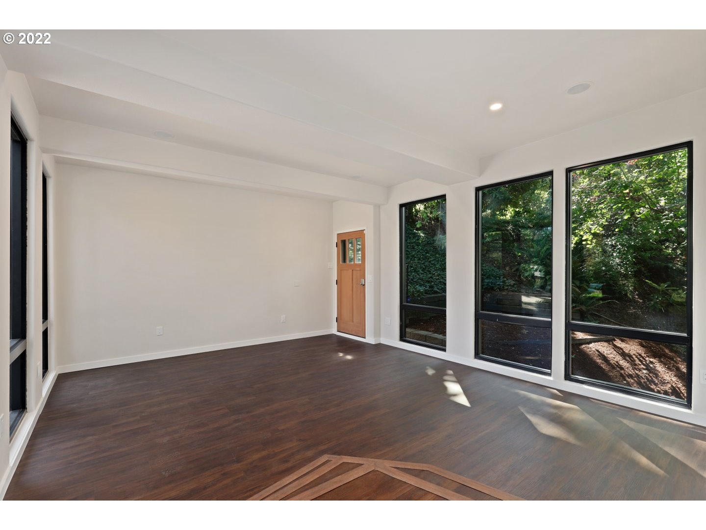 3143 Southwest Sherwood Place Portland, OR 97201 - Photo 10 of 32 a view of an empty room with wooden floor and a window