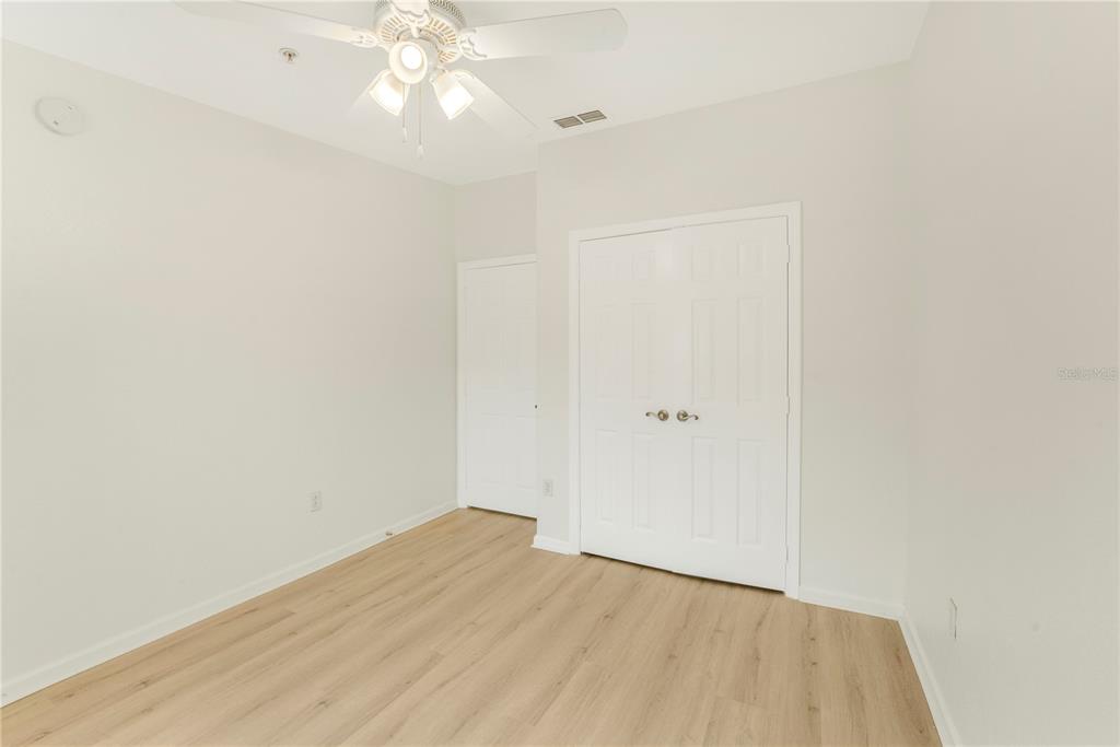 3351 Whitestone Circle, Unit 304 Kissimmee, FL 34741 - Photo 12 of 21 a view of a room with wooden floor and ceiling fan