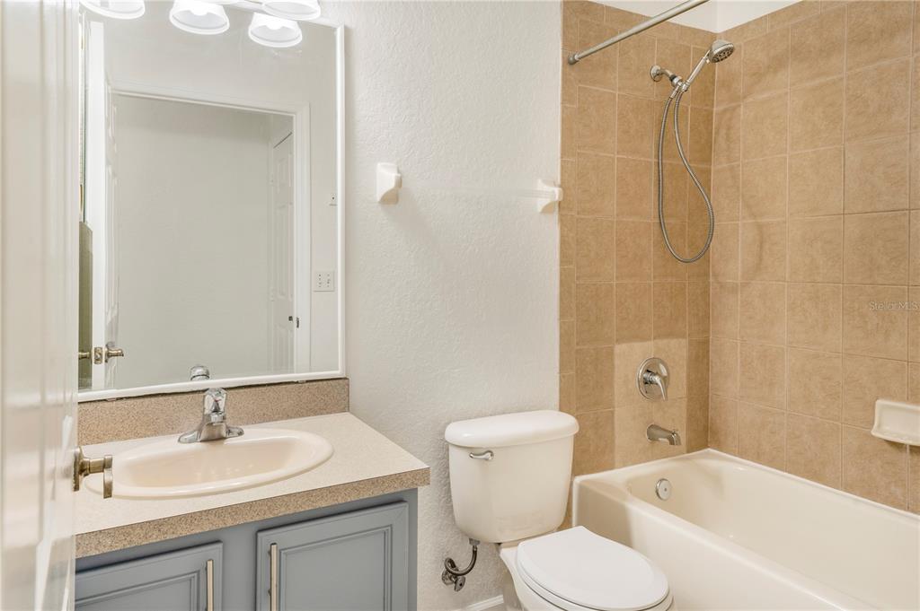 3351 Whitestone Circle, Unit 304 Kissimmee, FL 34741 - Photo 17 of 21 a bathroom with a sink toilet and shower