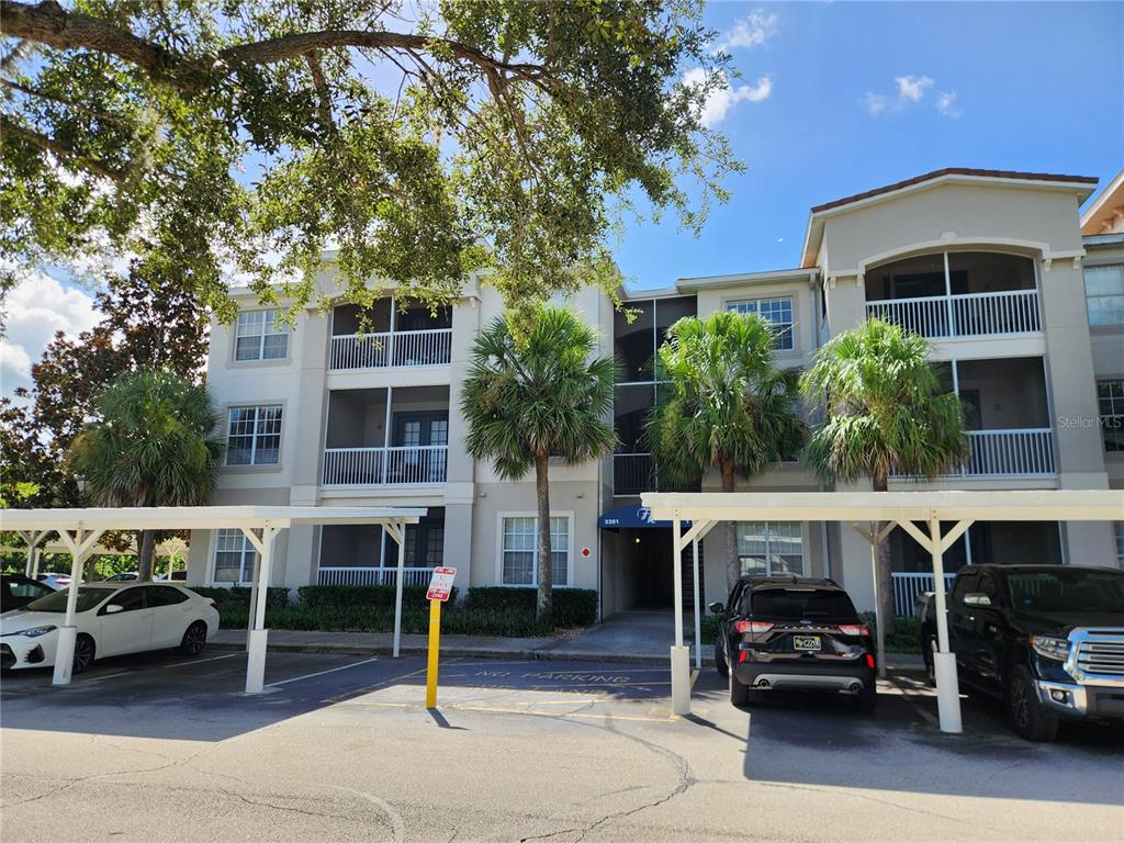 3351 Whitestone Circle, Unit 304 Kissimmee, FL 34741 - Photo 19 of 21 a front view of a building with parking