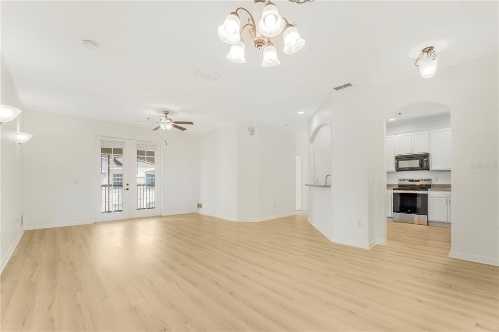 3351 Whitestone Circle, Unit 304 Kissimmee, FL 34741 - Photo 2 of 21 a view of a kitchen with wooden floor and a kitchen island