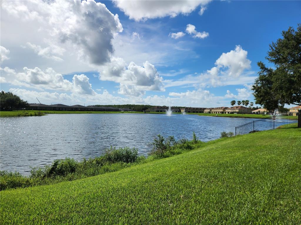3351 Whitestone Circle, Unit 304 Kissimmee, FL 34741 - Photo 21 of 21 a view of a lake with a big yard