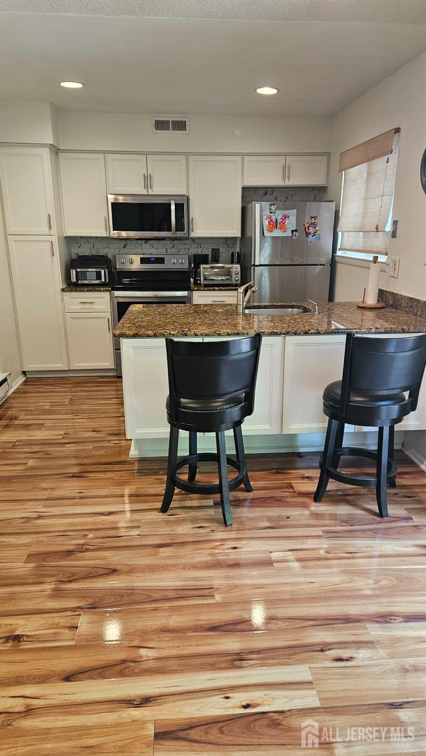 449 B Closter Road, Unit B Monroe Township, NJ 08831 - Photo 5 of 14 a room with stainless steel appliances kitchen island granite countertop a stove a sink and a refrigerator