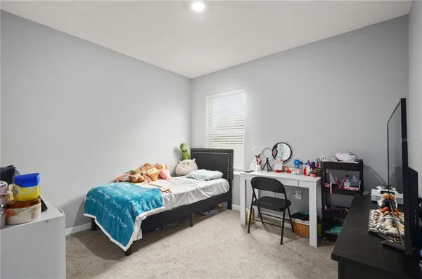a bedroom with a bed and a tv in it