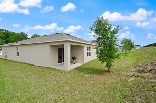 a view of a house with a backyard