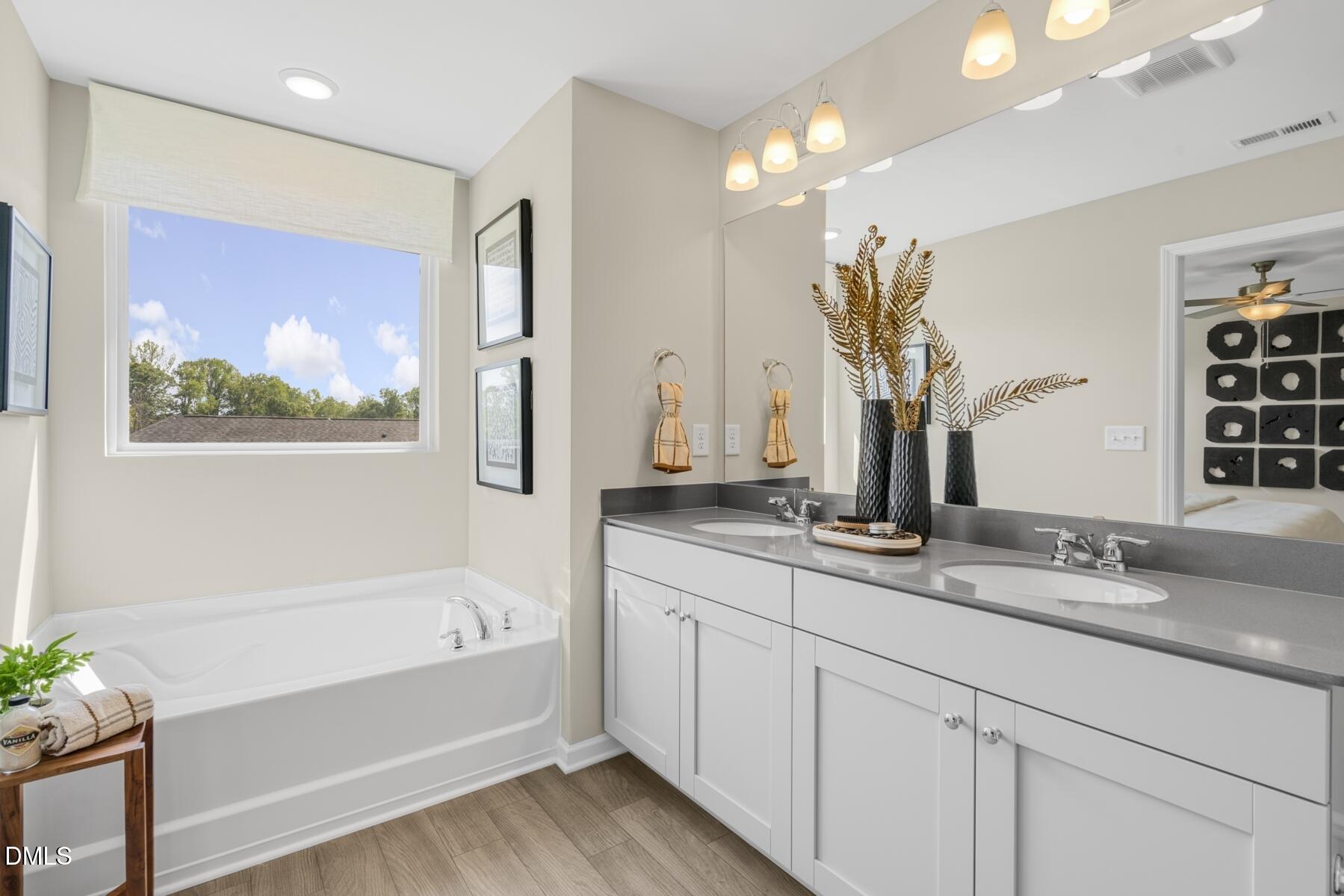 136 Lennei Lane Garner, NC 27529 - Photo 23 of 30 a bathroom with a tub sink and mirror