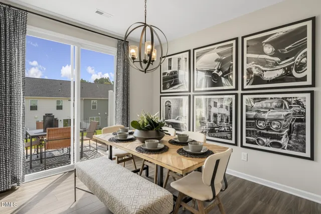 a dining room with furniture a chandelier and wooden floor
