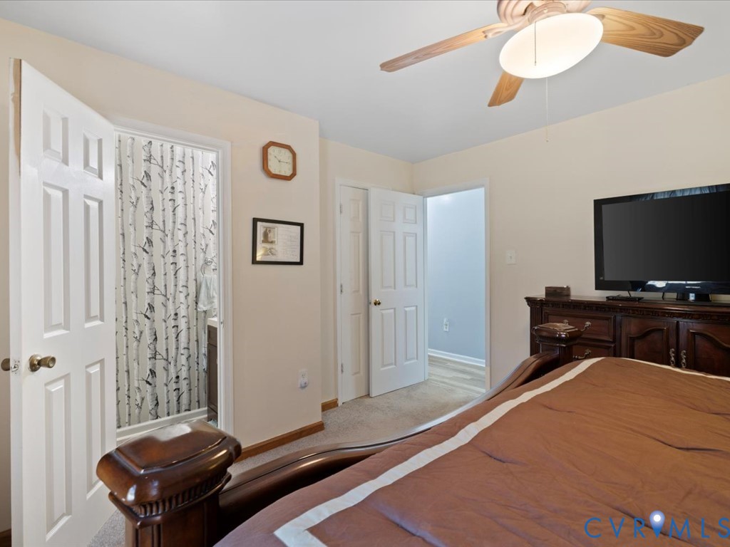 15415 Hopeful Church Road Bumpass, VA 23024 - Photo 19 of 27 a bedroom with a bed and a flat screen tv