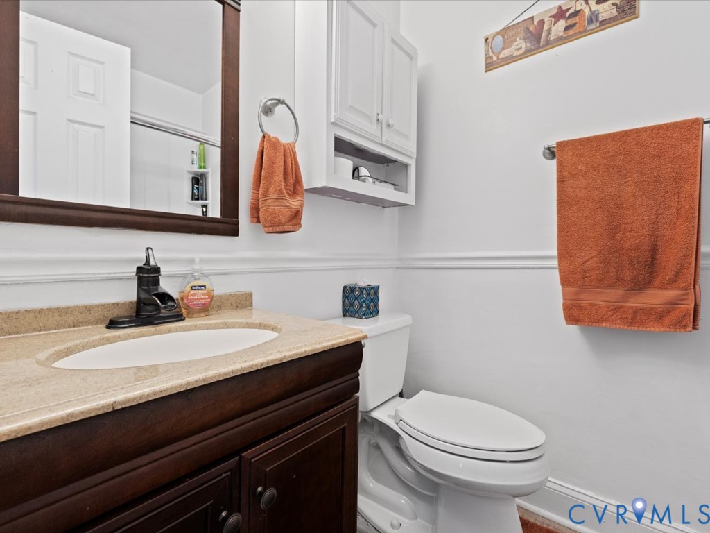 15415 Hopeful Church Road Bumpass, VA 23024 - Photo 19 of 27 a bathroom with a granite countertop sink and a mirror