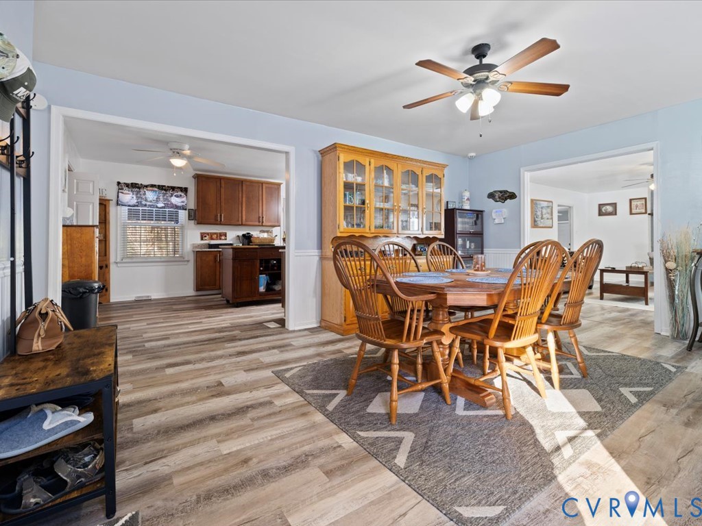 15415 Hopeful Church Road Bumpass, VA 23024 - Photo 4 of 27 a dining room with furniture a rug a fireplace and a chandelier