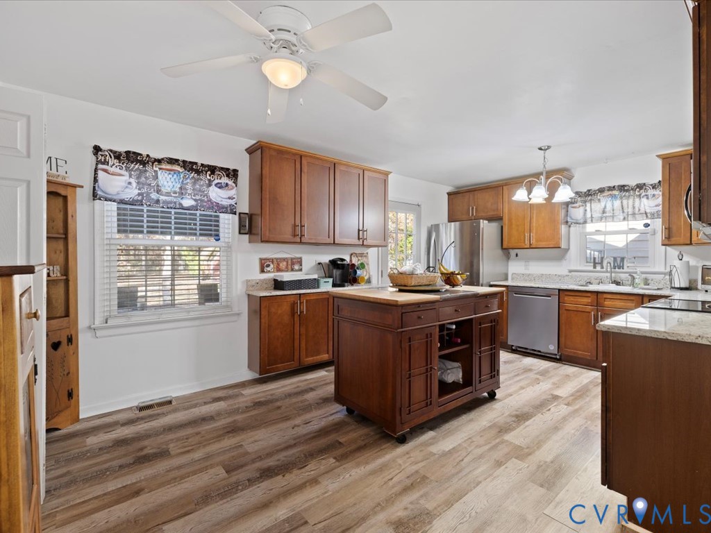 15415 Hopeful Church Road Bumpass, VA 23024 - Photo 5 of 27 a kitchen with stainless steel appliances granite countertop a stove a sink dishwasher and a refrigerator