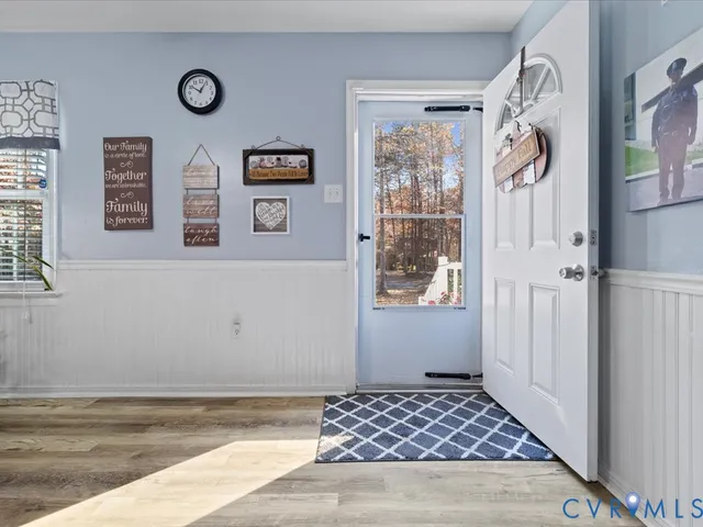 a dining room with furniture a rug a fireplace and a chandelier