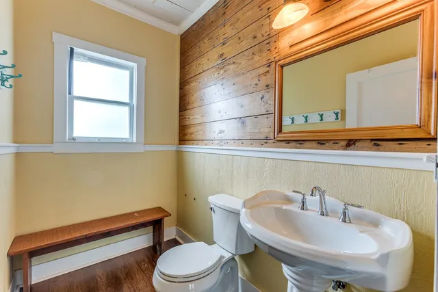 a view of hallway with wooden floor and chandelier