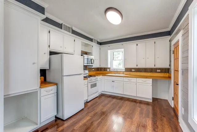 a white refrigerator freezer sitting inside of a kitchen