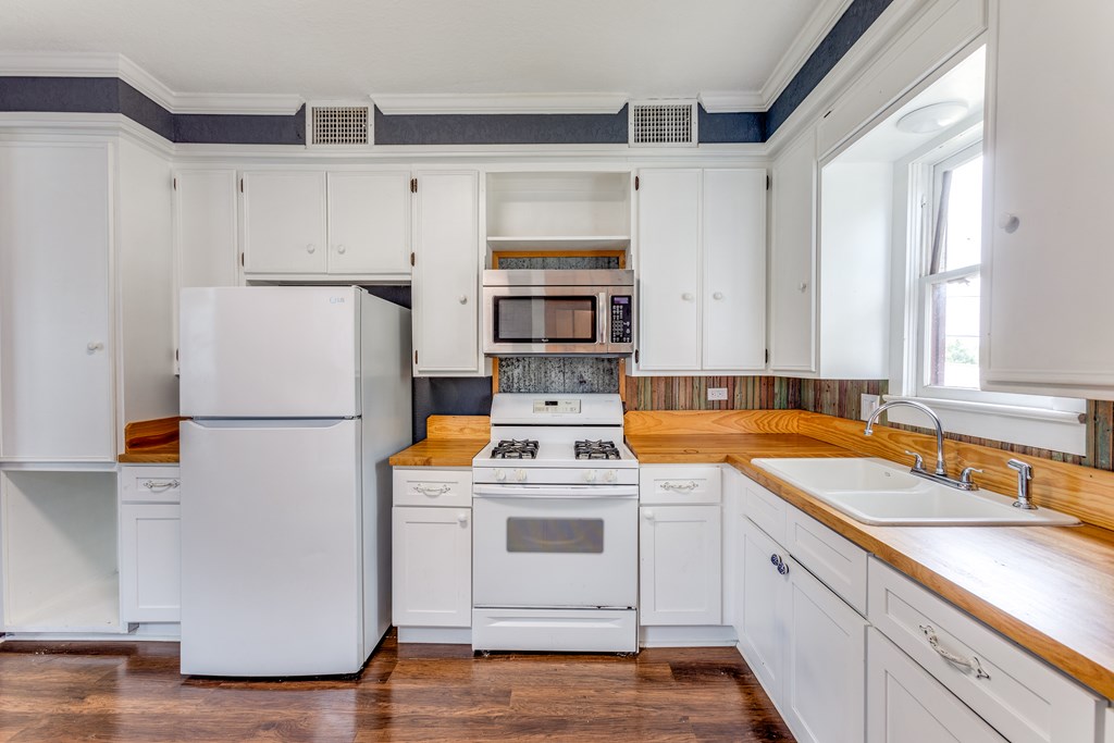 1600 Ford Street Llano, TX 78643 - Photo 18 of 37 a white refrigerator freezer sitting inside of a kitchen
