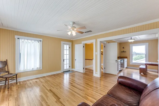 a living room with furniture and wooden floor