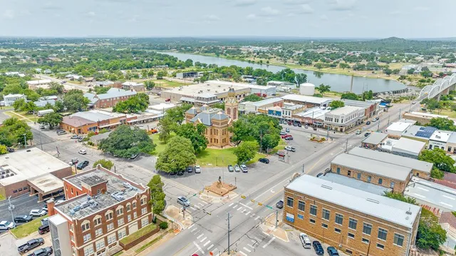 an aerial view of a house with a yard and lake view
