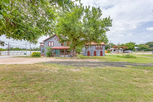 a front view of house with yard and green space
