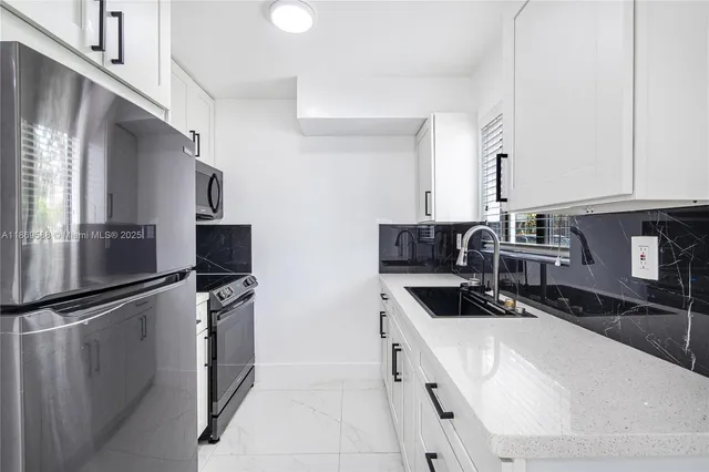 a kitchen with stainless steel appliances a refrigerator and a sink