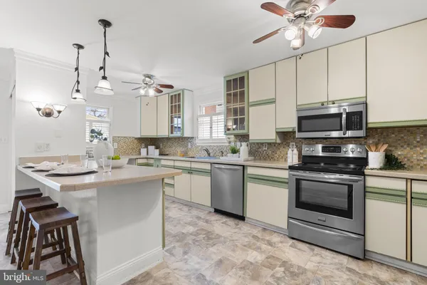 a kitchen with kitchen island a sink appliances and cabinets