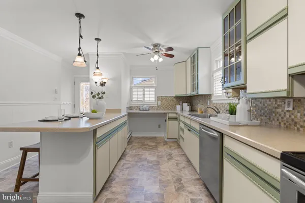 a kitchen with a sink refrigerator and window