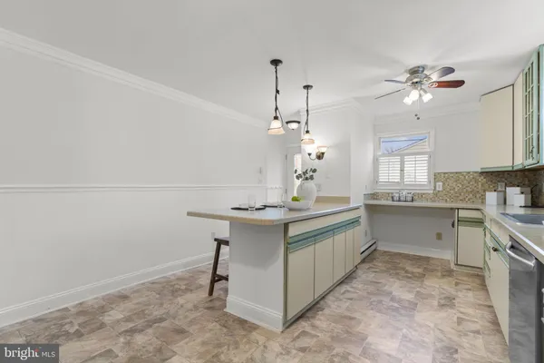 a view of a dining room and livingroom with furniture wooden floor a chandelier