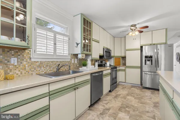 a bathroom with a sink a mirror a vanity and a shower