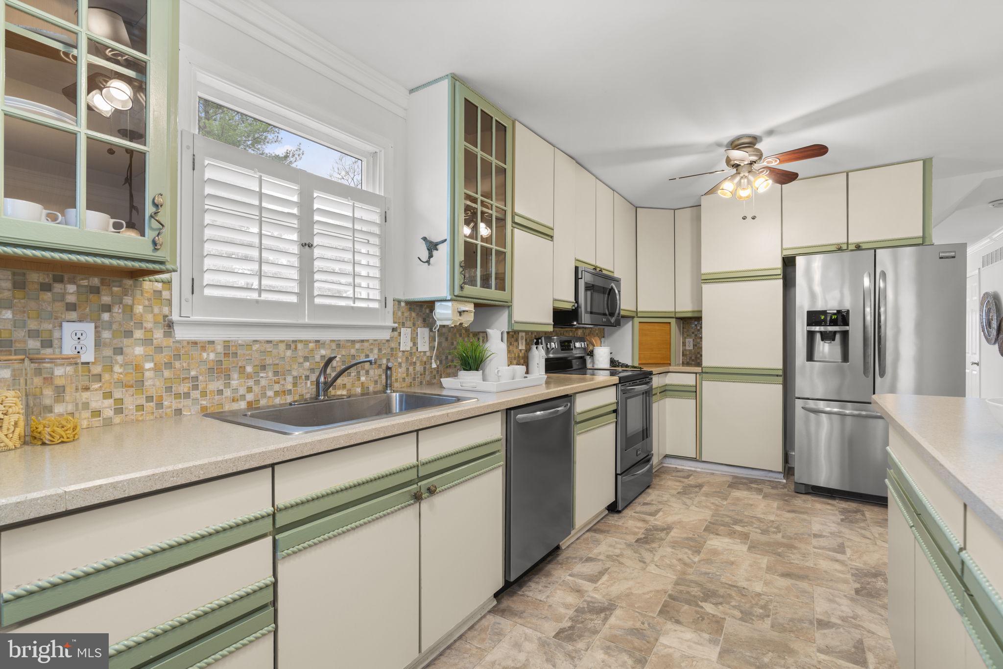 452 Carvel Beach Road Carvel Beach, MD 21226 - Photo 18 of 71 a kitchen with a sink refrigerator and window