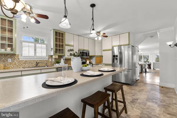 a living room with furniture a chandelier and a window