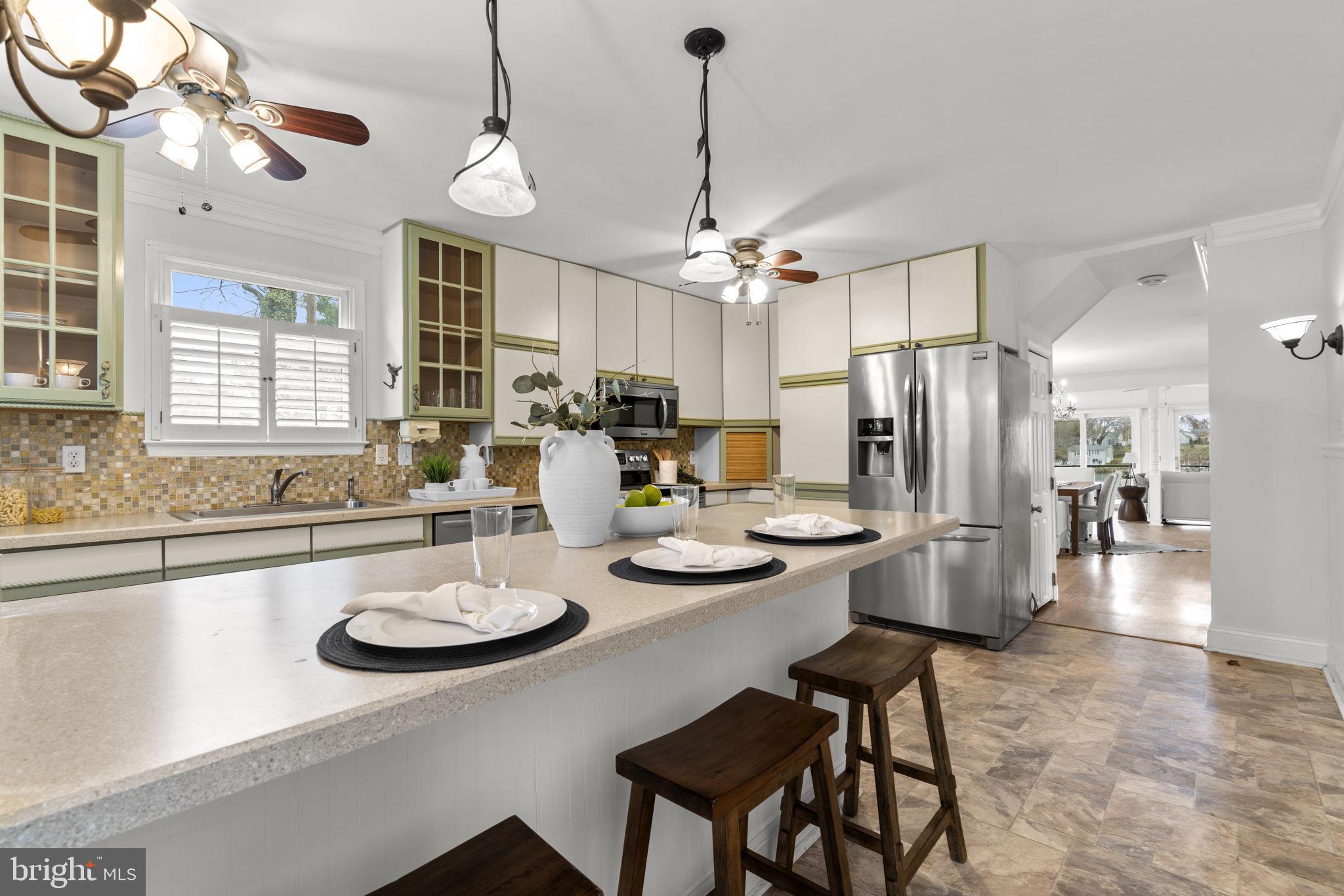 452 Carvel Beach Road Carvel Beach, MD 21226 - Photo 19 of 71 a view of a dining room and livingroom with furniture wooden floor a chandelier