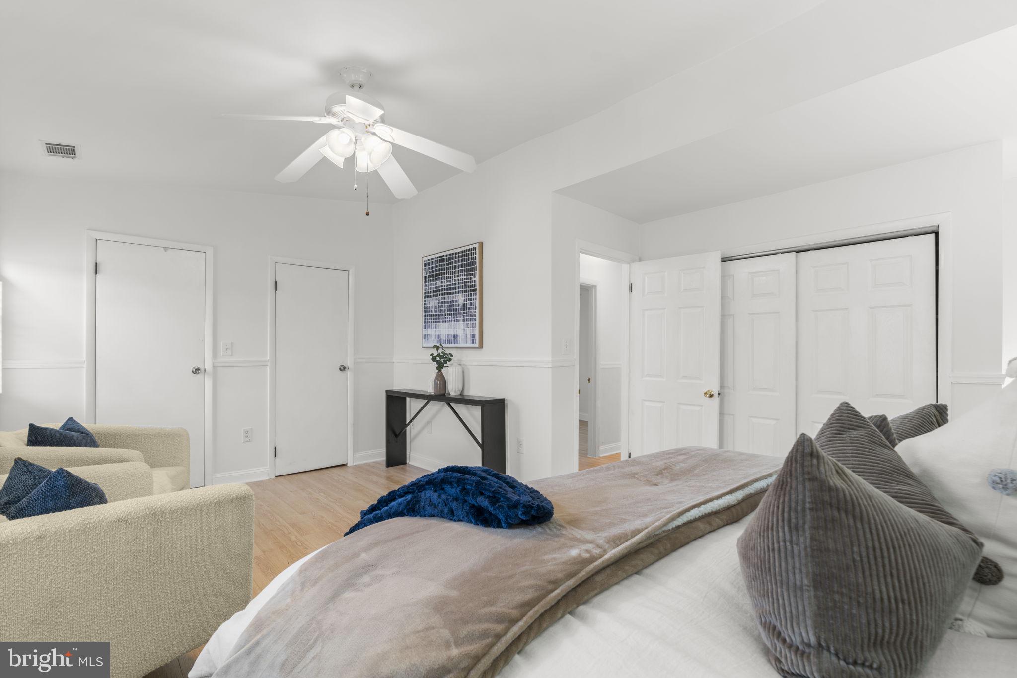 452 Carvel Beach Road Carvel Beach, MD 21226 - Photo 28 of 71 a bedroom with a bed and a chandelier
