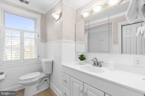 a view of a lake with a yard and a large tree