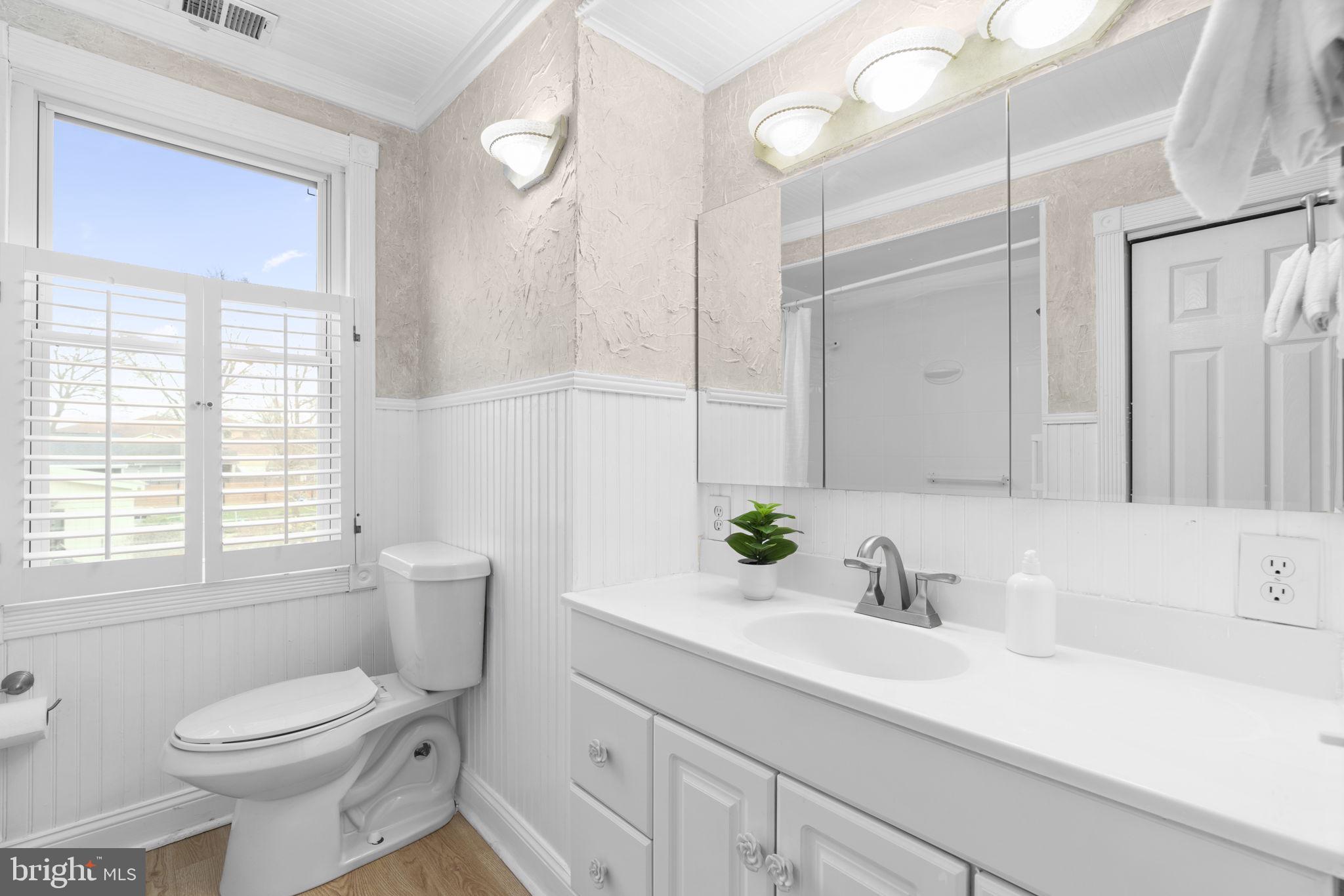 452 Carvel Beach Road Carvel Beach, MD 21226 - Photo 33 of 71 a bathroom with a sink a toilet and large mirror