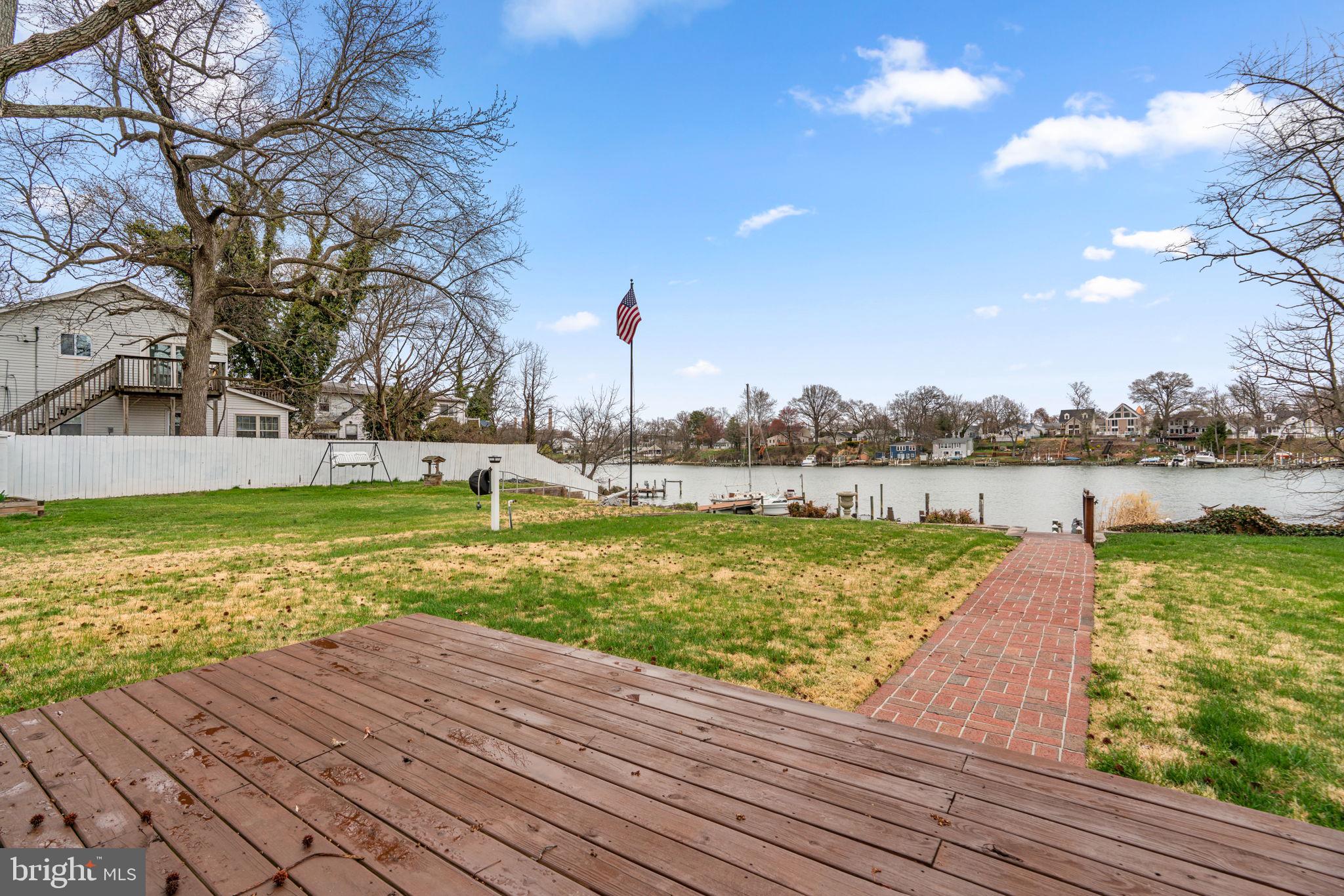 452 Carvel Beach Road Carvel Beach, MD 21226 - Photo 45 of 71 a view of a lake with a yard and a large tree