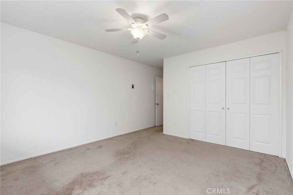 12200 Montecito Road, Unit D301 Seal Beach, CA 90740 - Photo 14 of 28 an empty room with a ceiling fan and a window