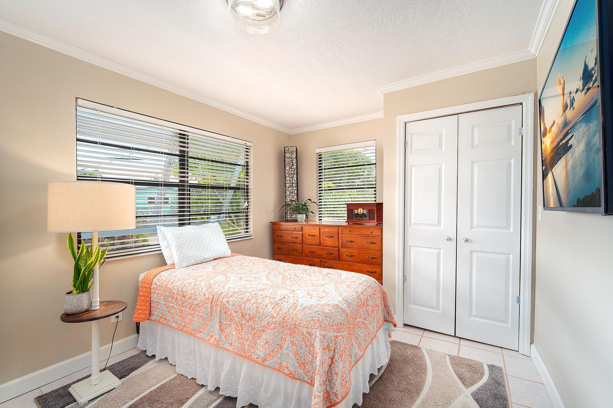 29827 Tropical Trader Road Big Pine Key, FL 33043 - Photo 12 of 32 a bedroom with a bed a potted plant and a window