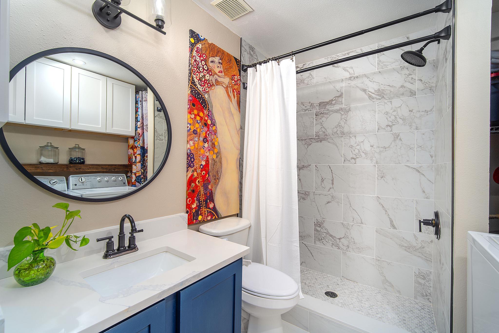 29827 Tropical Trader Road Big Pine Key, FL 33043 - Photo 16 of 32 a bathroom with a sink a mirror a vanity and a shower