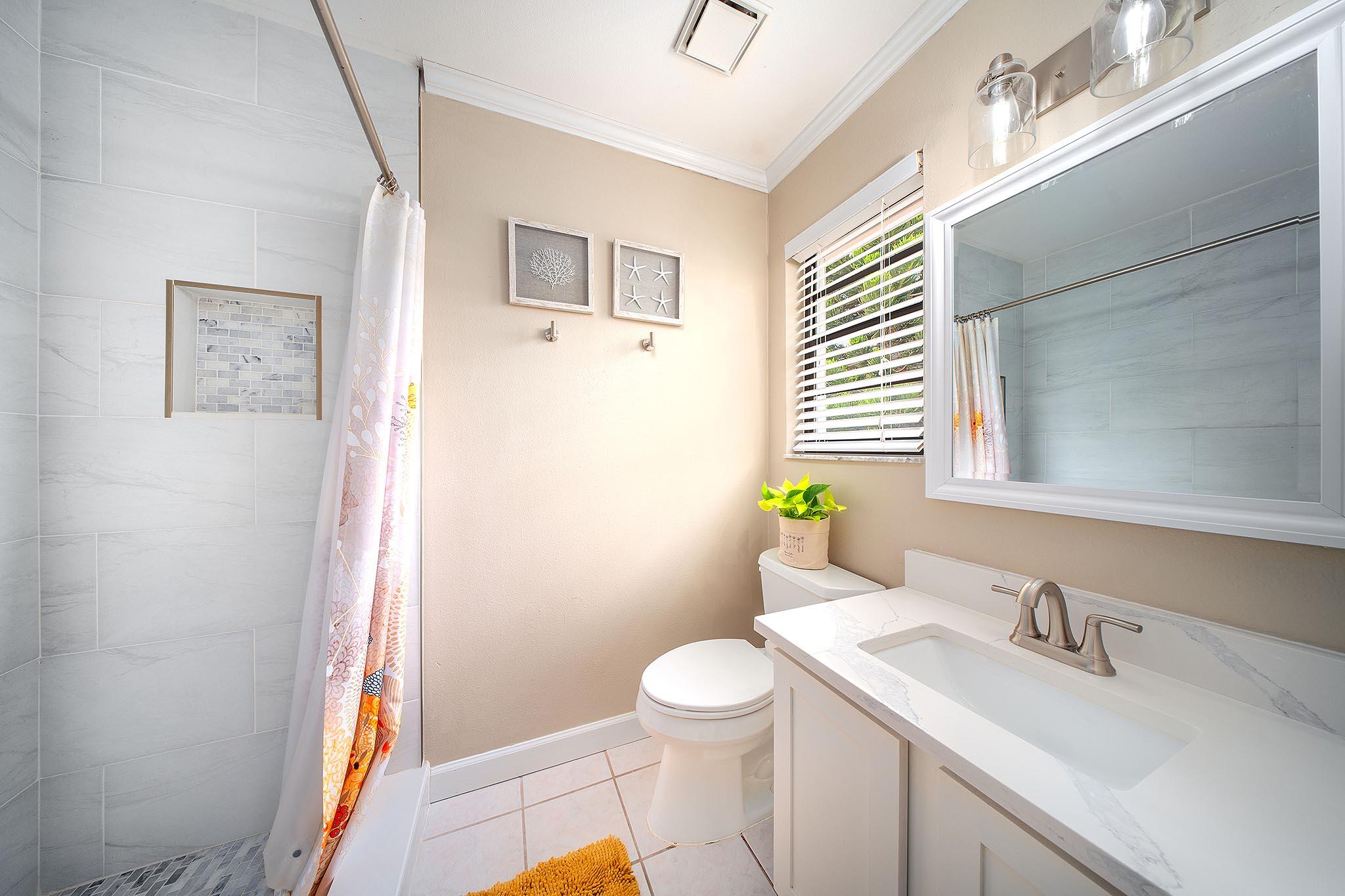 29827 Tropical Trader Road Big Pine Key, FL 33043 - Photo 19 of 32 a bathroom with a granite countertop sink toilet and a mirror
