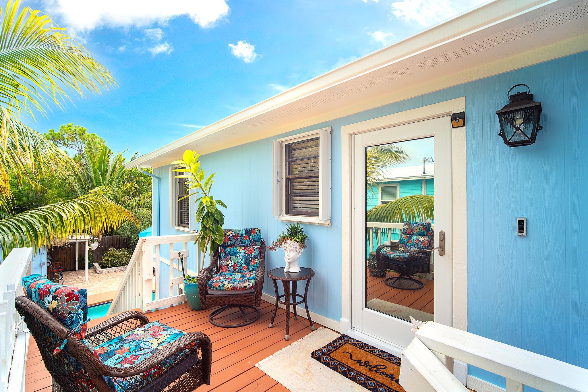 29827 Tropical Trader Road Big Pine Key, FL 33043 - Photo 20 of 32 a living room filled with furniture and a potted plant