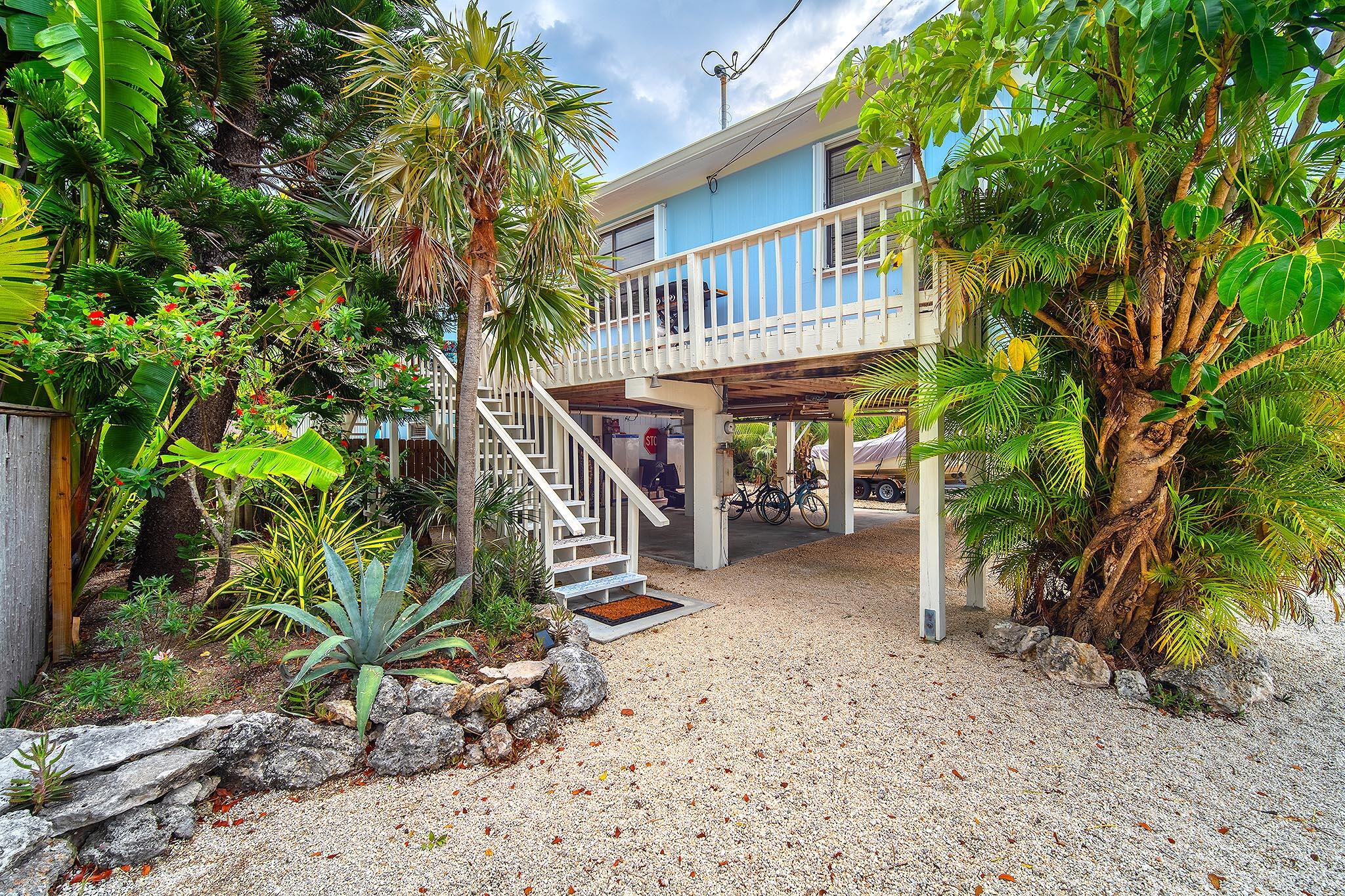 29827 Tropical Trader Road Big Pine Key, FL 33043 - Photo 32 of 32 a view of a house with a tree next to a yard
