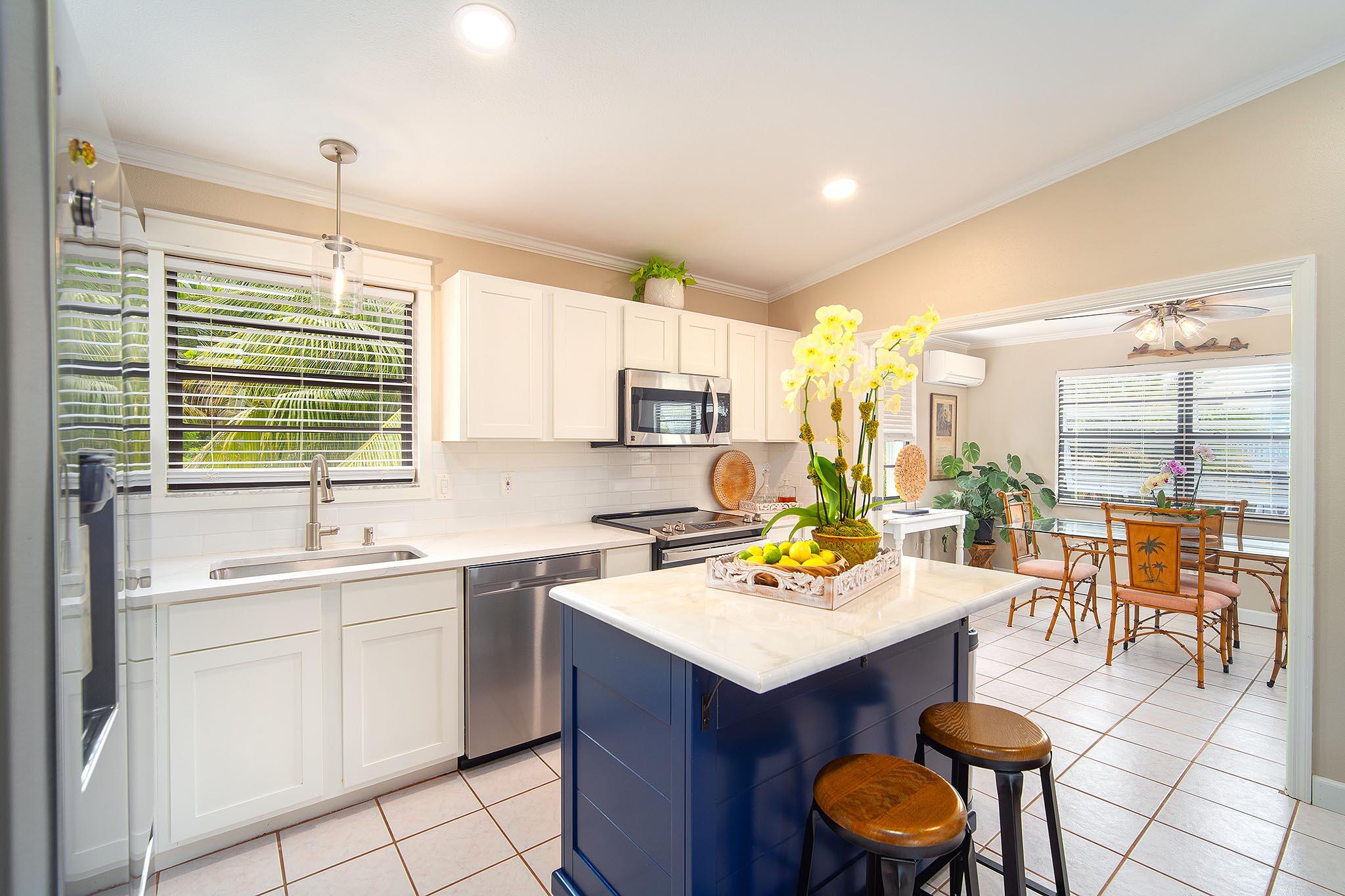29827 Tropical Trader Road Big Pine Key, FL 33043 - Photo 7 of 32 a kitchen with a sink a stove cabinets and chairs