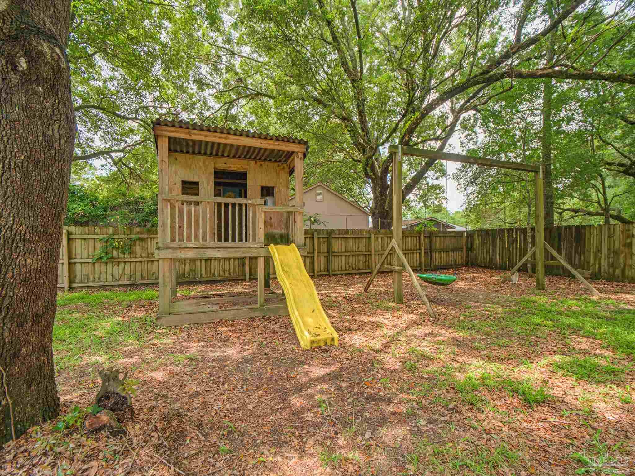 5567 Jones Street Milton, FL 32570 - Photo 46 of 48 a view of a backyard with a slide