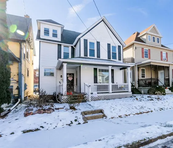 a front view of a residential apartment building with a yard